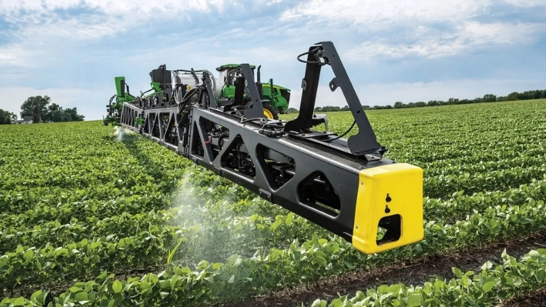Precision farming sprayer operating across crop field